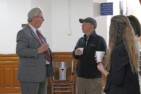 Exiting Hamilton County Attorney Mike Powell (left) enjoyed a small “retirement” celebration after the conclusion of Monday’s Hamilton County Board of Commissioners meeting. Many came to wish him well, including Commissioner John Thomas (center).