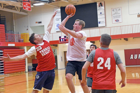 Class of 2018’s Henry Penner puts up a floater over 2002’s Casey Carlson during the Aurora alumni tournament finals. 