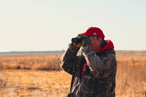 Jack Wergin peers through binoculars to get a better look at the birds at Teal View Wetland Education Area.