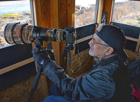 Bailey sits in a blind at the Rowe Sanctuary. The photo was taken by his daughter, Sarah Bailey.