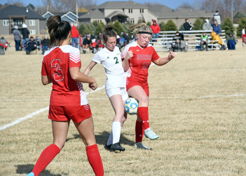 Aurora’s Addi Dummer battles for possession during a 2-0 loss to Kearney Catholic at home April 5. 