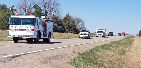 Firetrucks from throughout the state joined the funeral procession last week for Elwood Fire Chief Darren Krull, who lost his life in the line of duty April 7. Representatives from Aurora, Hampton, Giltner and Phillips fire departments made the trip west, joining a long processing from the church to the cemetery, or parking at intersections along the route.