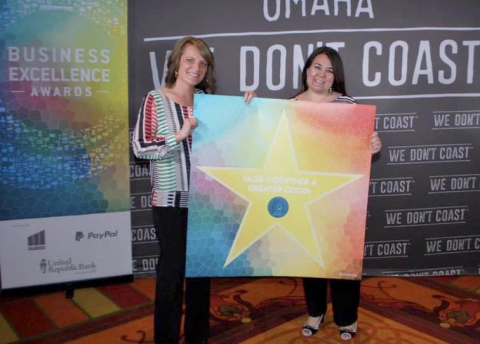 Holly Baker (left) and Leslie Fisher hold up a star with their business name, Together A Greater Good, at the 2016 Business Excellence Awards in Omaha. The business, which allows customers to donate a portion of their receipt to charitable causes, has about 10,000 active users. 