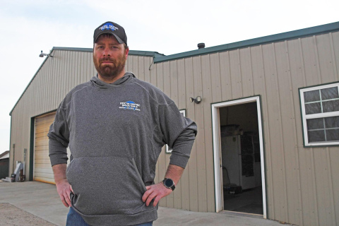 Scott Bauer stands outside his Postal Mopar workshop on the edge of town in Phillips. After eight years of being co-owner, Bauer aquired sole-ownership of the business earlier this year. 