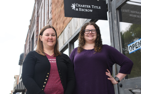 Head of marketing Heather Griffrow (left) and escrow closer Hannah Prusia stand in Charter Title & Escrow in downtown Aurora. The offices have recently been renovated from a photography studio.  