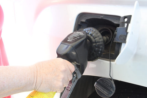 Marquette resident Kim Archer fills up her tank at the Aurora Mall. Prices at gas stations have caused her and some other residents to delay visiting family or taking vacations. 