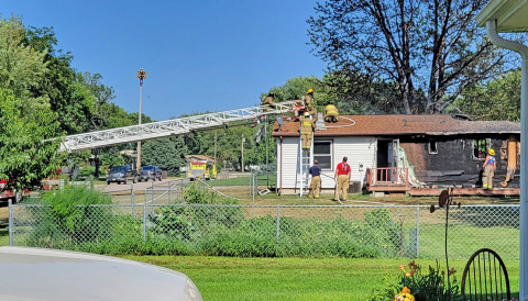Firefighters perform cleanup duties after it took two hours for responders from Hampton, Aurora and Bradshaw to put out the fire.