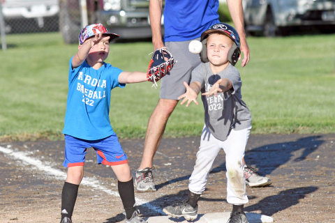 Blue team’s Walter Lyon was just trying to do his job at first base in an effort to make the play while Grey team’s Watson Lorence decided to lend a helping hand. 