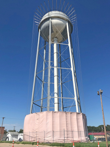 The Aurora water tower shown with the tank partially sandblasted Work on the project is expected to be finished by early September.