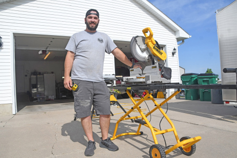 Ryan Freeman, owner and founder of Freebird Construction, LLC, poses in front of his table saw while on a job on 1st Street in Aurora. Freeman has founded his own business after nearly a decade of construction work in Hamilton County.