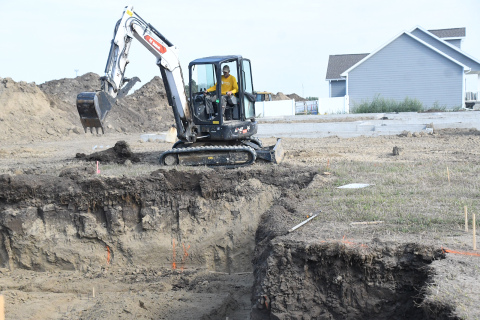 Crews work on a digging a new basement for a single-family dwelling in the Streeter Subdivision Thursday. Two recently poured basements can be seen in the background, represented three of five buidling permits issued for houses last month.