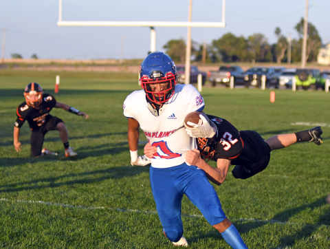 HPC's Mario Lesiak runs through the attempted tackle of Giltner's Kale Bish. 