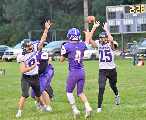 Hampton's Kash Majerus (81) and Wyatt Dose pressure the quarterback in the Hawks' 65-6 win at Elba Thursday night. 