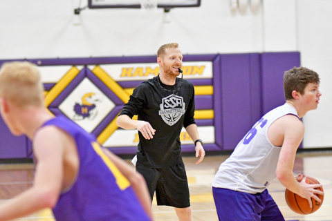 New Hampton basketball coach Dalton Miller runs through practice drills during preseason workouts earlier this month as the Hawks ready for the 2022-23 season, which opens Thursday. 