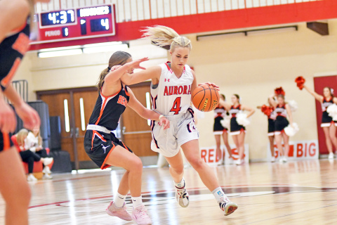 Aurora’s Denae Nachtigal dribbles around a Beatrice defender during Aurora’s 66-36 loss at home Saturday. 