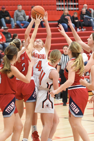 Aurora junior Denae Nachtigal fights for a rebound against Norris Dec. 20 in a game which the Lady Titans used its height to full advantage.