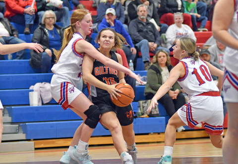 Giltner’s Addison Wilson attempts to drive between the HPC duo of Peyton Hofmann (left) and Hailey Lindburg.