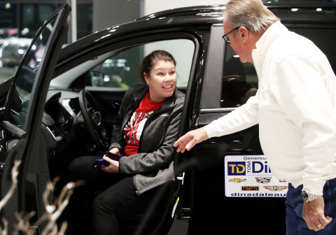 Jill Kottwitz is congratulated by Tom Dinsdale shortly after winning a 2022 GMC Terrain in Thursday’s Heartland United Way 25 Keys of Christmas car give-away.