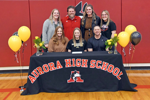 Eva Fahrnbruch signed her letter of intent to Nebraska Wesleyan Jan. 11 alongside her parents, Dustin and Deborah, as well as Aurora softball coaches back from left, Emily McCartney, Joe Vanderpool, Ashton Voss, Kaylee Freese. 