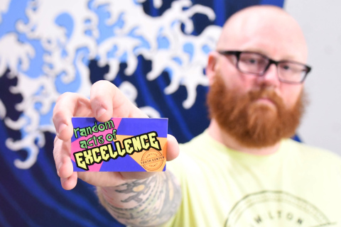 Paul Johnson shows off a Random Acts of Excellence card in the Zen Room at the Hamilton County Youth Center. The cards are awarded to middle and high school students for good behavior allowing youths to get free treats and gift cards. 