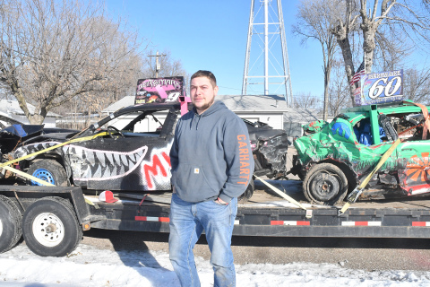 Driver Scott Bergmark in front of his derby vehicle on the left and brother Jamie’s on the right, that they ran at Cornhusker’s Chaos in Kearney this year, on a trailer near his Phillips home. Bergmark started racing as an 11-year-old child and competed in demolition derby since 2016.