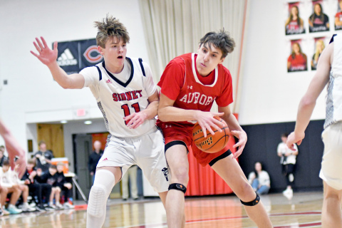 Booker Scheierman absorbs contact through the lane in Aurora’s 34-31 loss to Sidney in the C1-6 district final. 