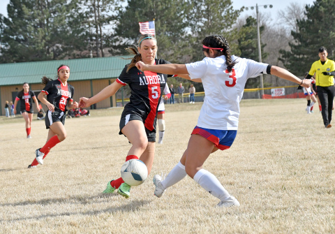 Aurora’s Madisyn Willis tries to get around a Crete defender with the ball in the first half of a 4-0 win against the Cardinals Thursday. 