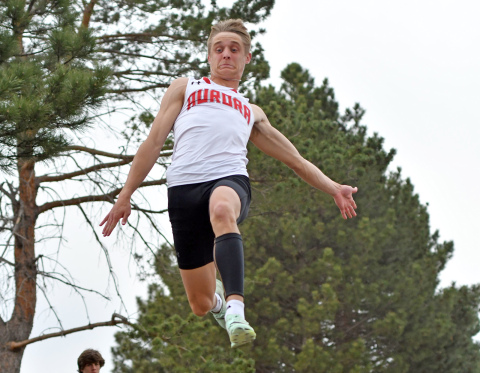 Aurora senior Carsen Staehr floats over the sand pit during one of his three long jump attempts at the Central Nebraska Track Championships Monday. Staehr earned outstanding male athlete with meet records in the long and triple jumps. 