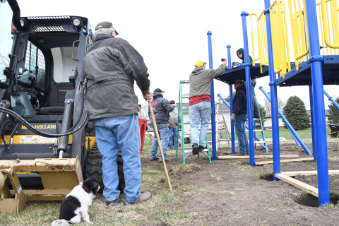 Messiah Lutheran Church volunteers, also with a supervising dog, help put together playground equipment. After more than five years and $65,000, the playground will be open to members and the wider community.