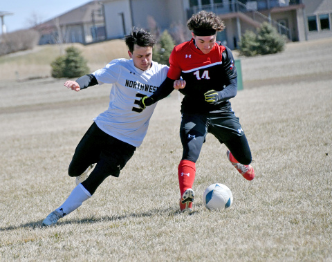 Aurora’s Keegan Chaney gets physical for possession during the Huskies’ 3-0 loss to Northwest Saturday. 