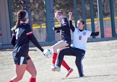 Aurora’s Aubrey Murray, who scored her first goal against Lakeview, battles for possession against Ralston. 