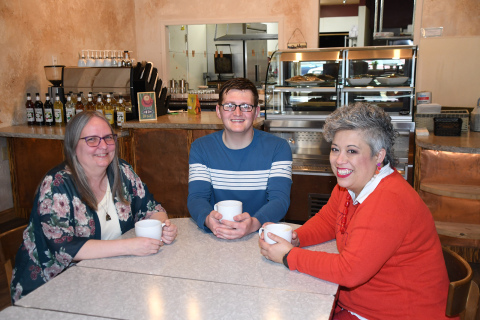 Announcing the debut of The Leadership Center at Espressions are, from left: shop manager Lisa Montoya, barista Wyatt Griess and Maile Ilac Boeder, executive director of The Leadership Center.