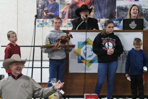 Auctioneer Kelly Kliewer, with help from several others including John Thomas out front, watches for bids during the annual MCC Auction this weekend in Aurora.