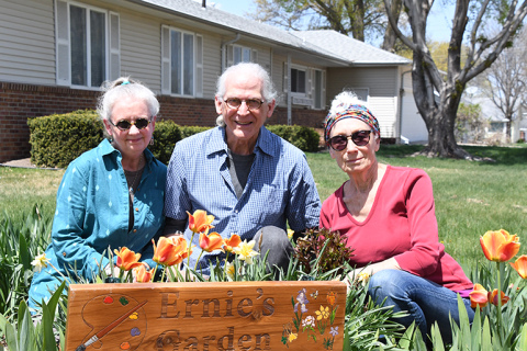 The current caretakers are seen here among the flowers of Ernie’s Garden. From left are Barbara and Britton Bailey along with the founder’s wife, Lynda Ochsner. Since artist and Alice M. Farr Library custodian Ernie Oschner passed away last fall, the Baileys have continued to take care of the garden with Lynda’s approval.