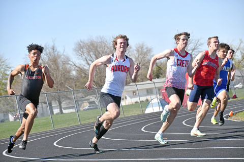 Aurora’s Koby Nachtigal (second from left) rounds the turn in the 200 meter dash finals at the Central Conference meet in Schuyler. Nachtigal finished second in the 200, just after winning the 100 dash final. 