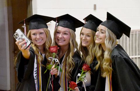 Husky grads capturing a selfie include, from left: Kirsten Jensen, Kasey Schuster, Fahrnbruch and Kylie Svoboda.