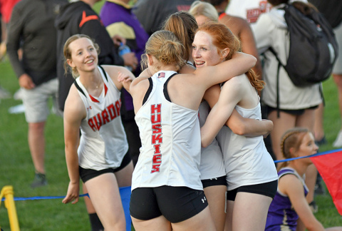 Aurora’s 1600 relay team of Adi Fahrnbruch (far left) Eva Fahrnbruch, Jordyn Slagle and Kendal Wineteer celebrate after a new PR time and second place finish. 