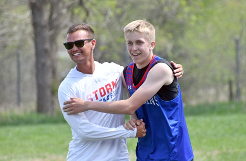 Richard Rhoden High Plains track coach Darius Williams (left) and Brodey Spurling celebrate after Spurling’s district championship in the 110 high hurdles at the D-2 district meet in Osceola. 