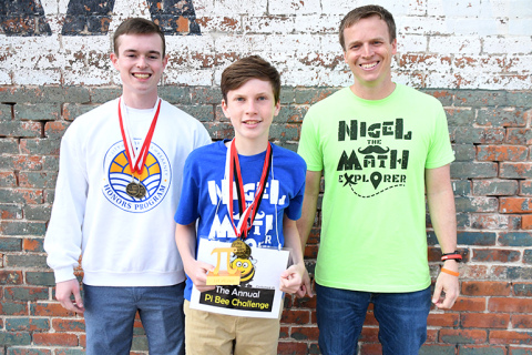 Shawn Morris, center, is the new Pi Bee record holder, having recited 402 digits of pi on the last day of school. He is pictured with his cousin and former record holder, Alex Peters at left, and math teacher Scott Phillips.