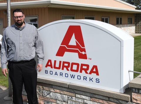 Company president and CEO Gary Bales debuts a new sign out in front of the business, which changed its name this week from International Sensor Systems Inc. to Aurora Boardworks.