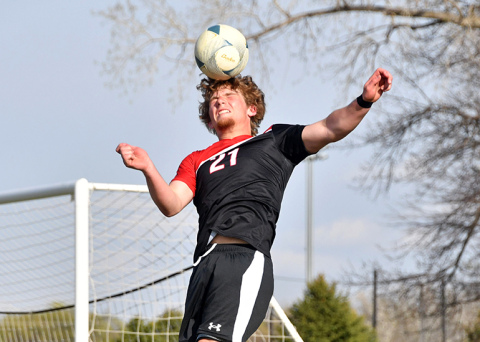 Britton Kemling reached out for a header in the offensive zone during Aurora’s 2-0 win over Holdrege Thursday. 