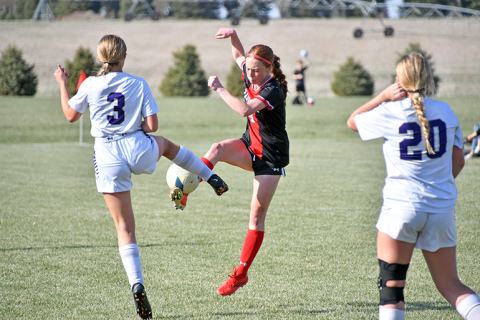 Aurora’s Hannah Janda wins a ball on the offensive end during the Lady Huskies’ 4-0 win over Holdrege Thursday. 