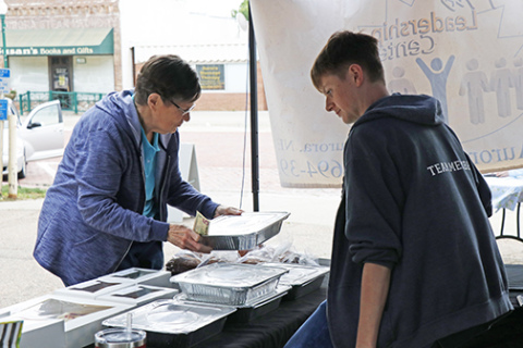 A vendor helps a customer during last year's Market on the Square, a series of Saturday events which begins this weekend.
