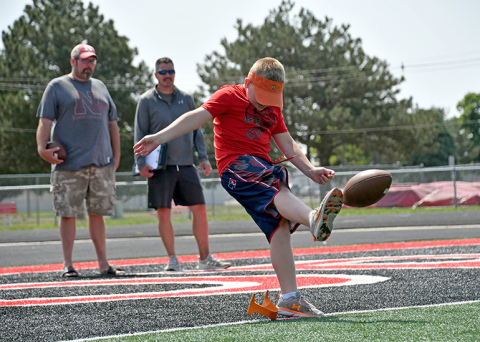 A youngster participates in Friday's Punt, Pass & Kick event in Aurora.