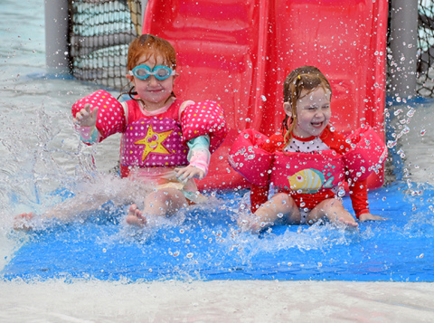 Youngsters enjoy opening day at the swimming pool in Aurora Friday.