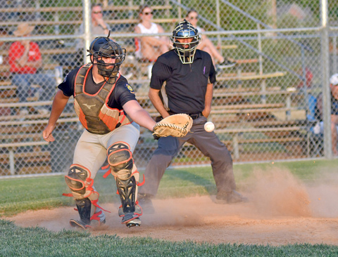 Dylan Dubas scrambles to corral the ball behind the plate during the Pinnacle Bank Seniors’ 12-11 win over Twin River last week. 