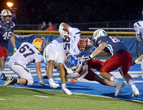 Carlos Collazo slams into North Platte’s Kolten Tilford at the goal line, breaking the plane for a touchdown in the South’s 17-7 win over the North in the 65th annual Shrine Bowl game at UNK Saturday night. 
