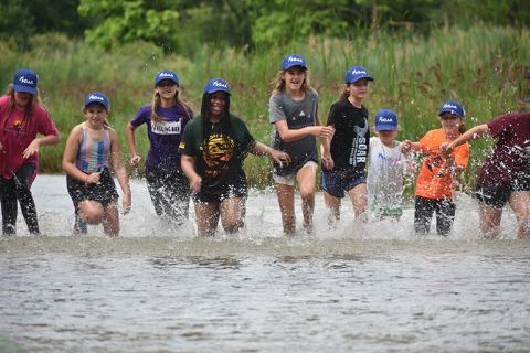 This year’s summer SOAR campers cooled off, and herded fish toward a waiting net down stream, by splashing in the river during river day.