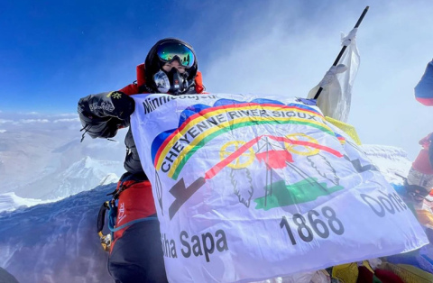 Jacob Weasel, Cheyenne River Sioux Tribe, holds the flag of his people while at the summit of Mount Everest. Weasel is the husband of Aurora native Lauren (Paschke) Weasel, who shared her life’s journey in an ANR feature published April 19.