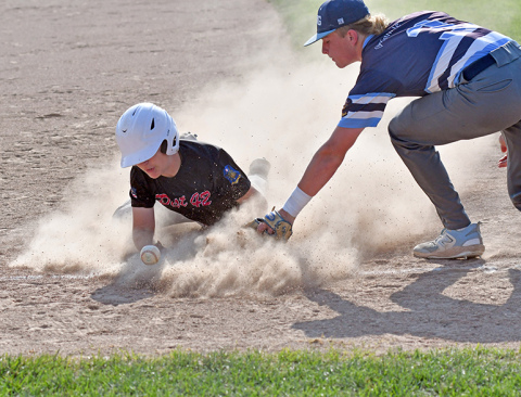 Aurora’s Keelan Phillips gets dirty into third base during a continuation game against PWG June 27. 